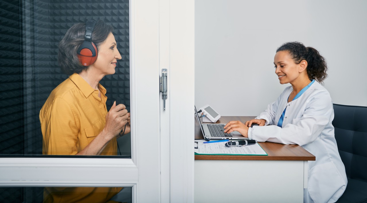 Provider with a woman getting a hearing test